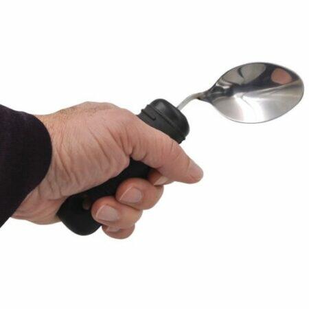 A person's hand holding a Torsogrip Flexible Spoon.