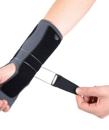 A person holds a Ligaflex Pro wristband.