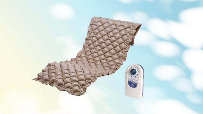 An anti-bedsore mattress with a remote control next to it.