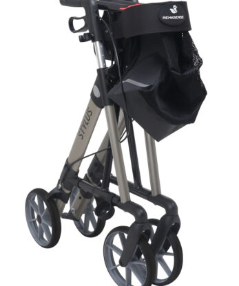 A folded Rollator Stylus with four wheels and an attached mesh storage bag, branded 